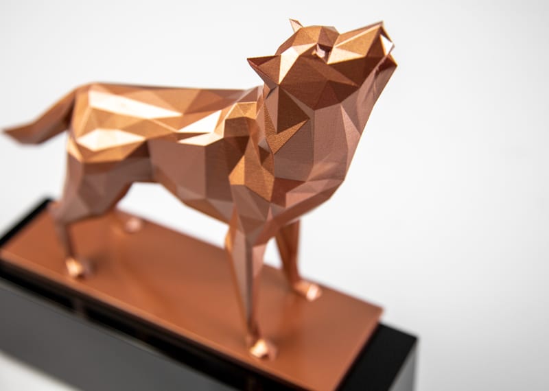 Brass 3D printed geometric wolf on black crystal base