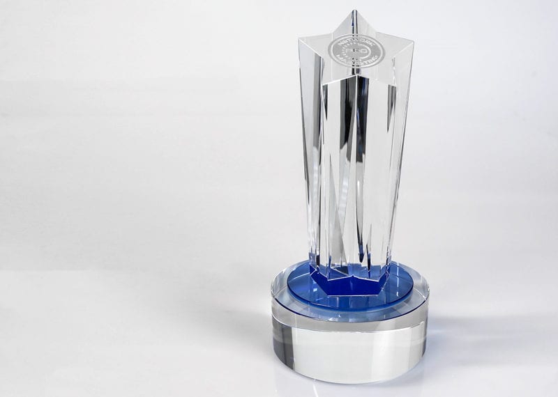Crystal star trophy with blue crystal on base.