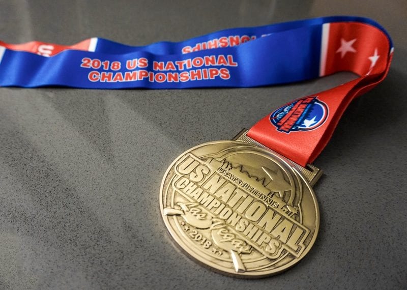 Gold medal with red and blue ribbon