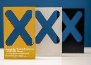 Brushed gold, silver, and black metal awards with ”X” cutout