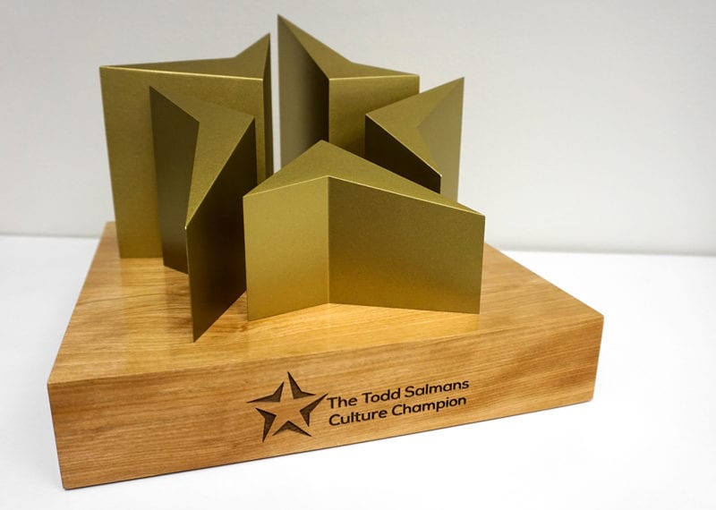 Gold metal star logo recreation on wood base. Laser burned personalization