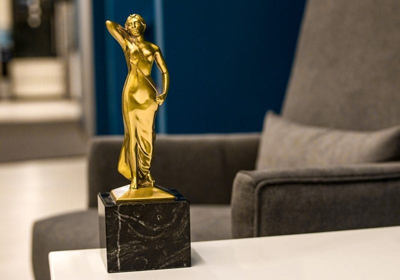 gold award statue woman on marble base