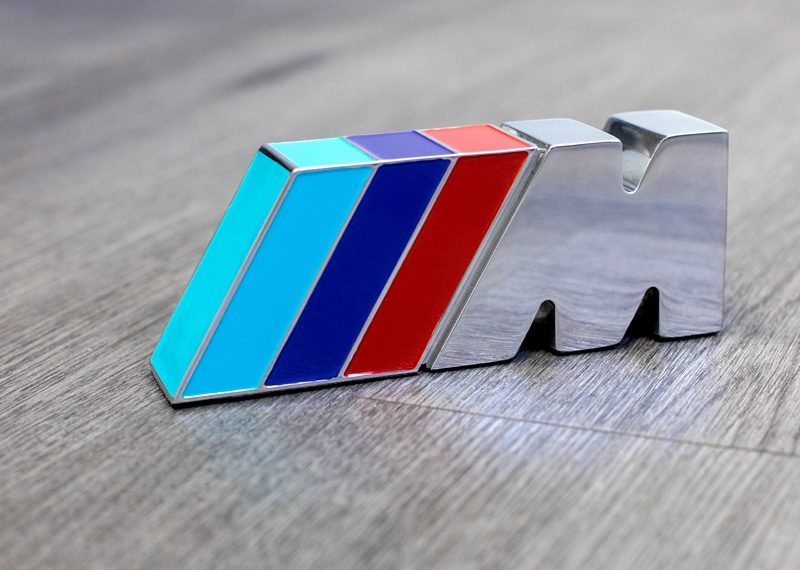 EDM wire cut and polished metal with colored enamel paint fill. Custom BMW M3 logo creation.