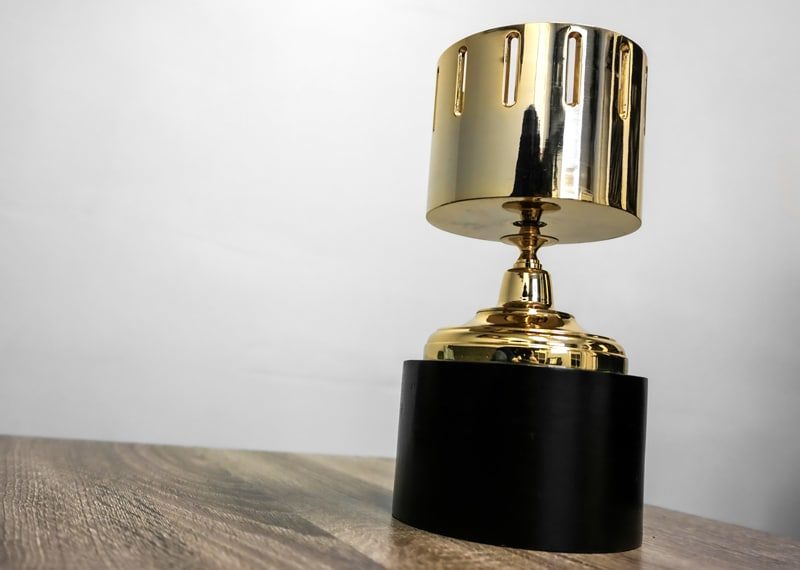 Gold trophy film reel spinning top.