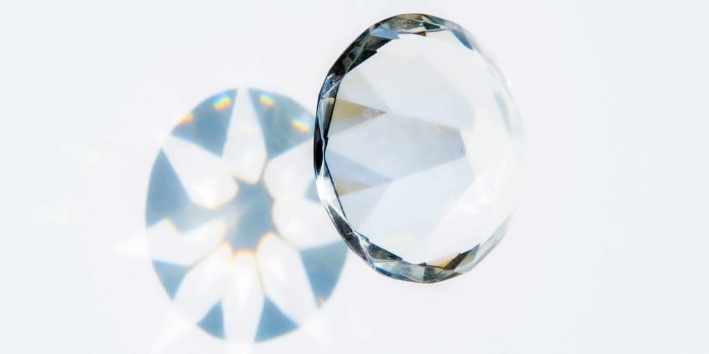 Faceted diamond cut optical crystal and reflection