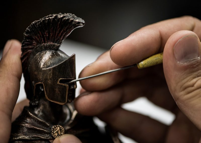 Bronze resin spartan statue being cleaned