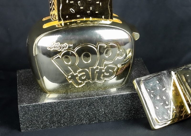 gold poptart toaster replica on stone base