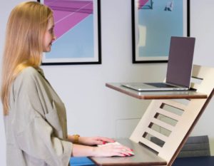 woman standing at desk working