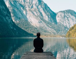 man relaxing at a lake