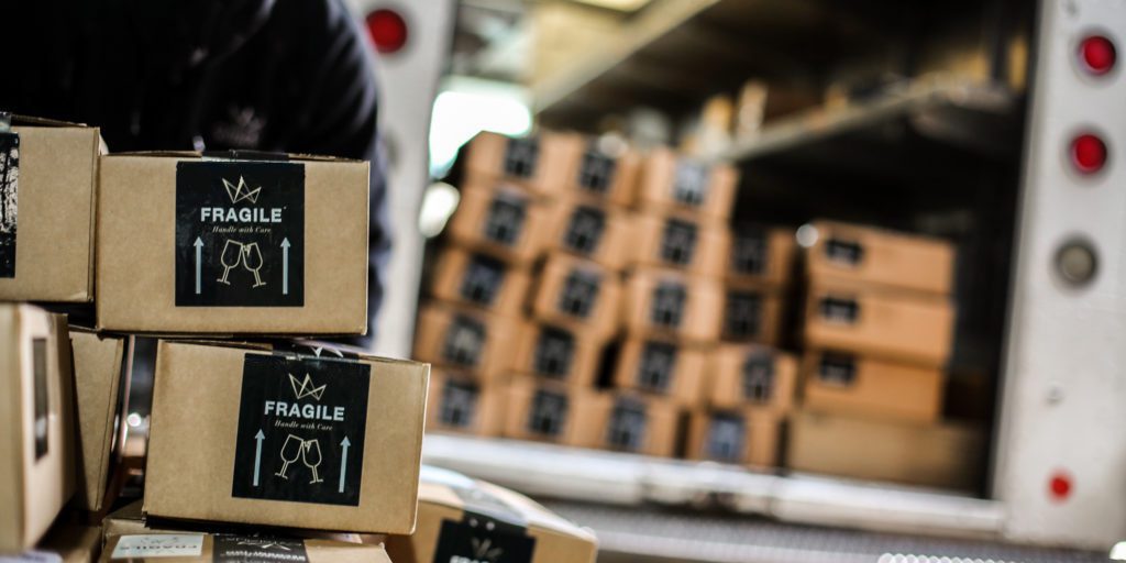 Cristaux branded shipping boxes being loaded into FedEx truck for Drop Ship